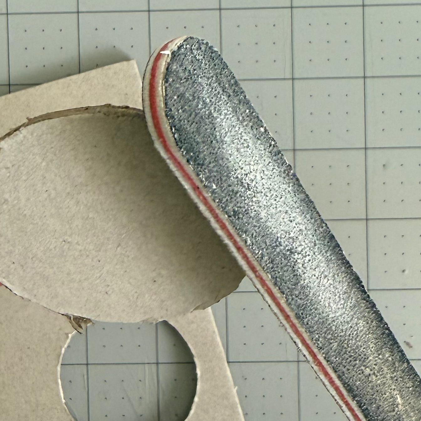 Filing the rough edge of a cut chipboard circle