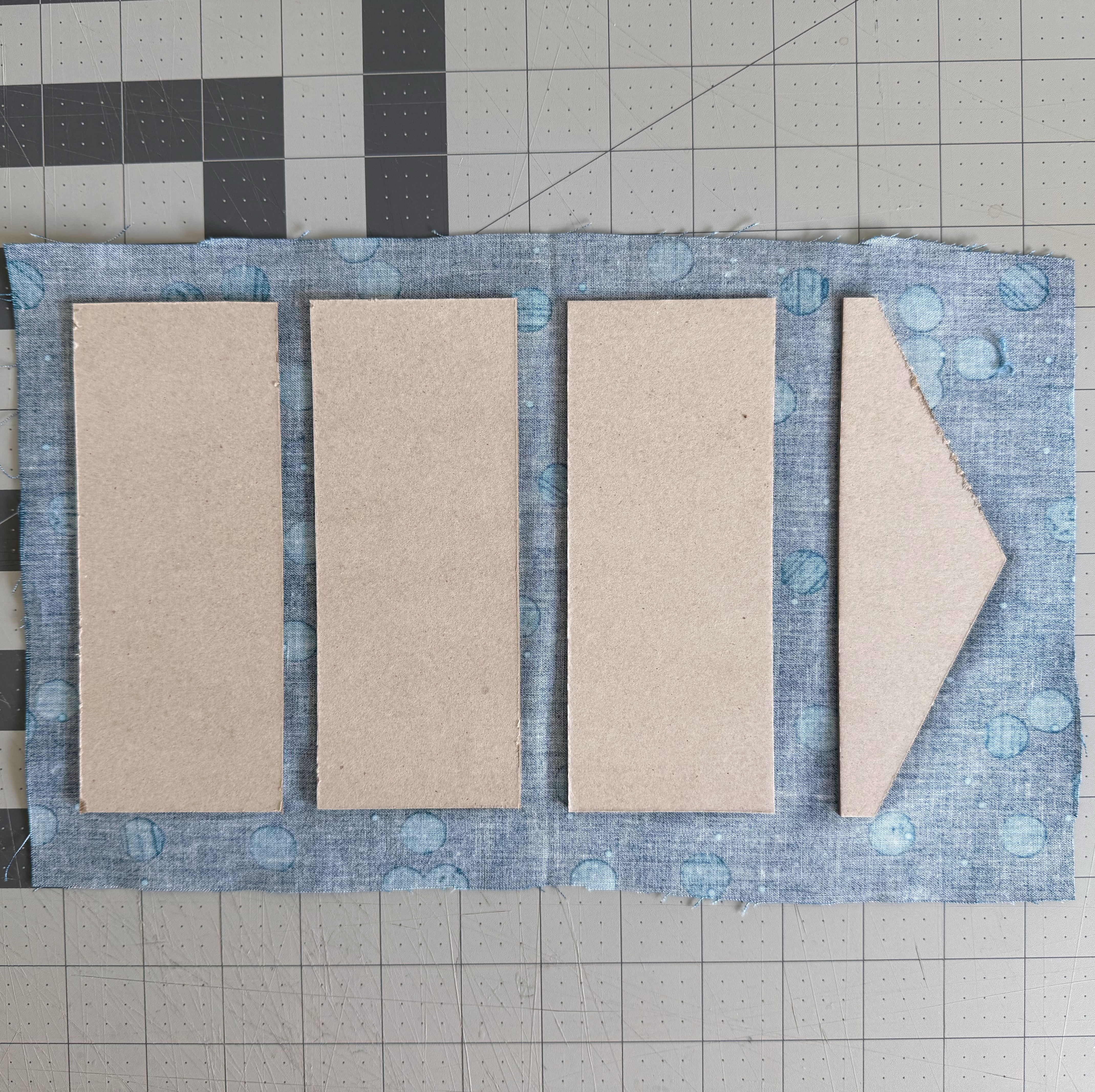 An irregular chipboard piece glued in position on exterior fabric