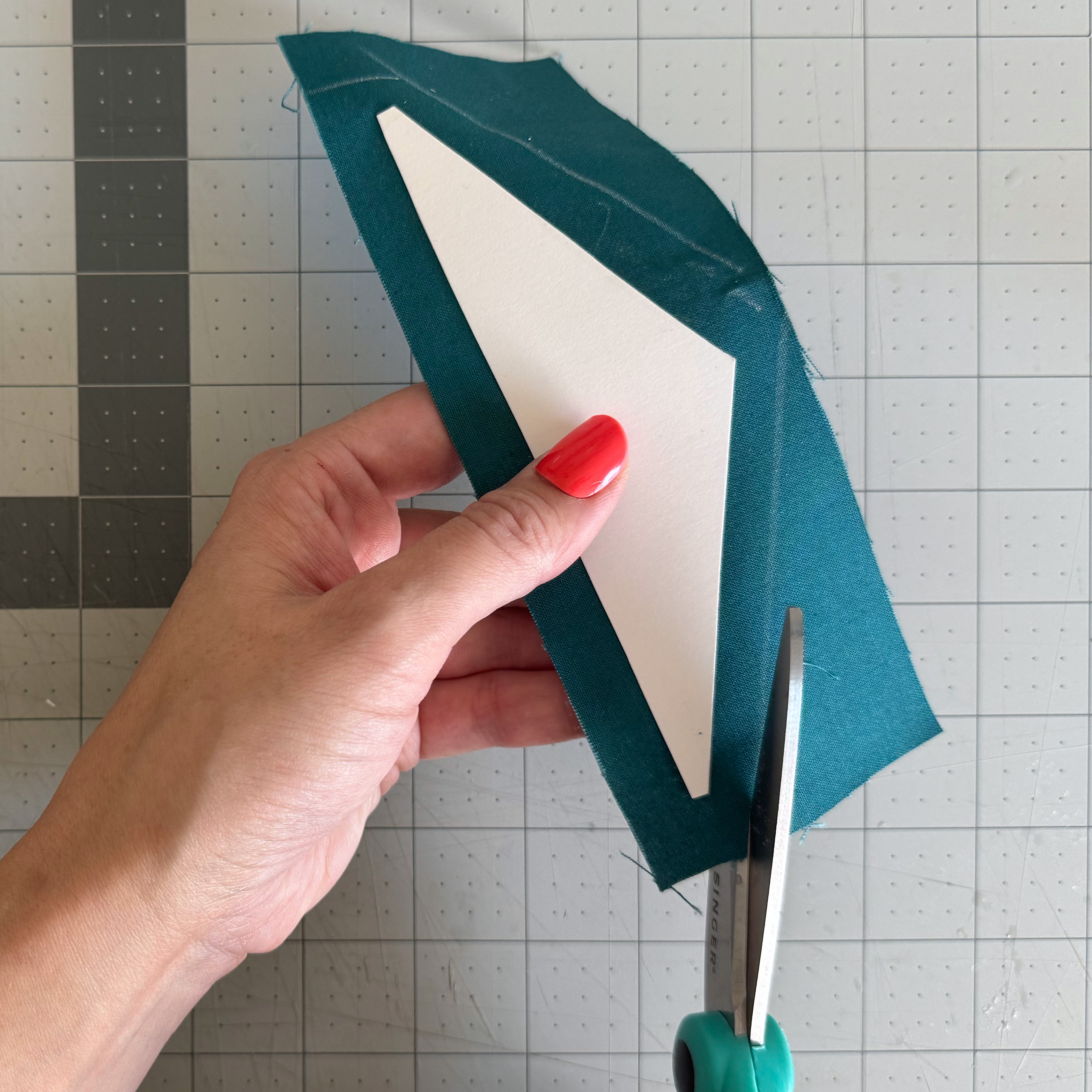 A paper template positioned for tracing an irregular cardstock shape