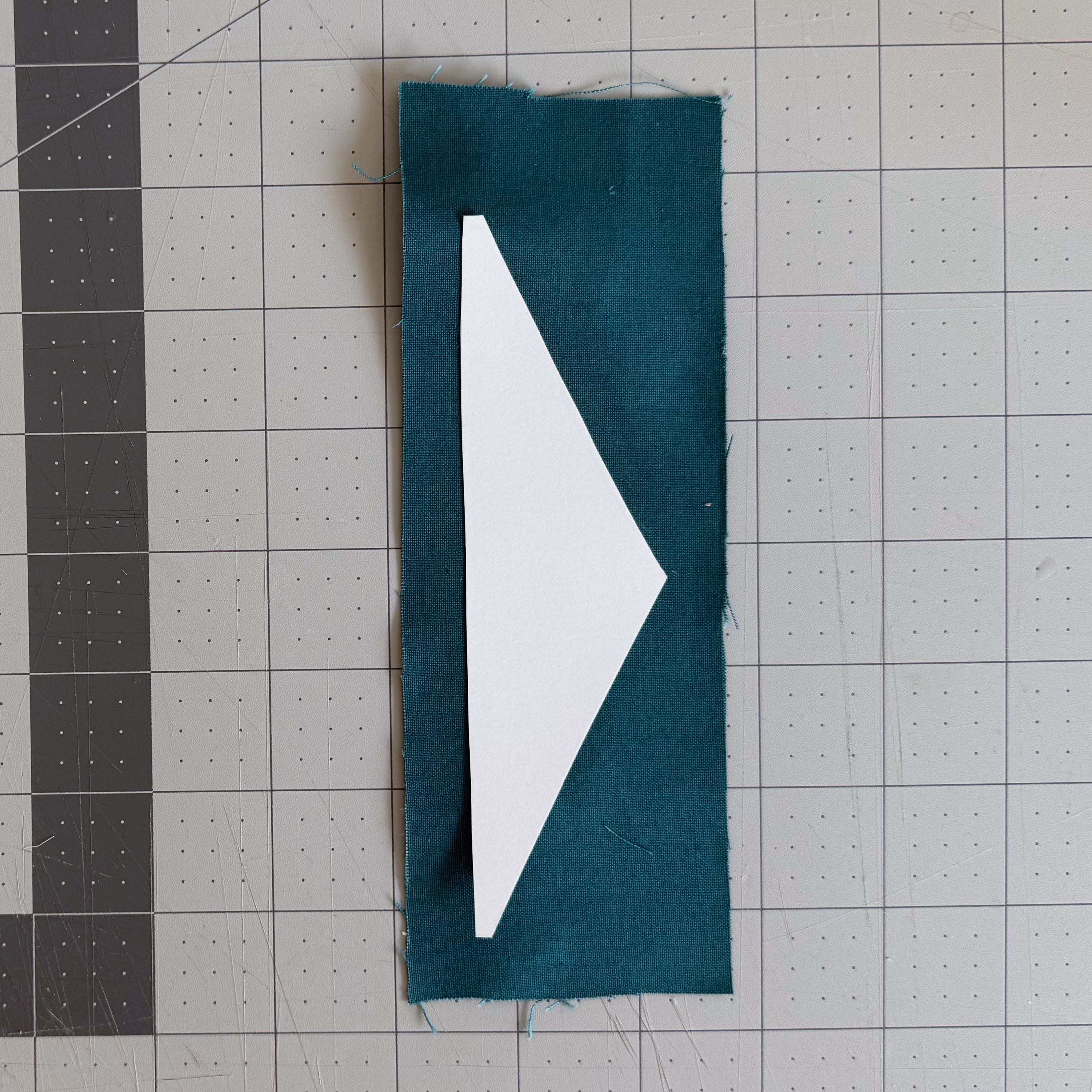 An irregular cardstock lining glued to the wrong side of fabric