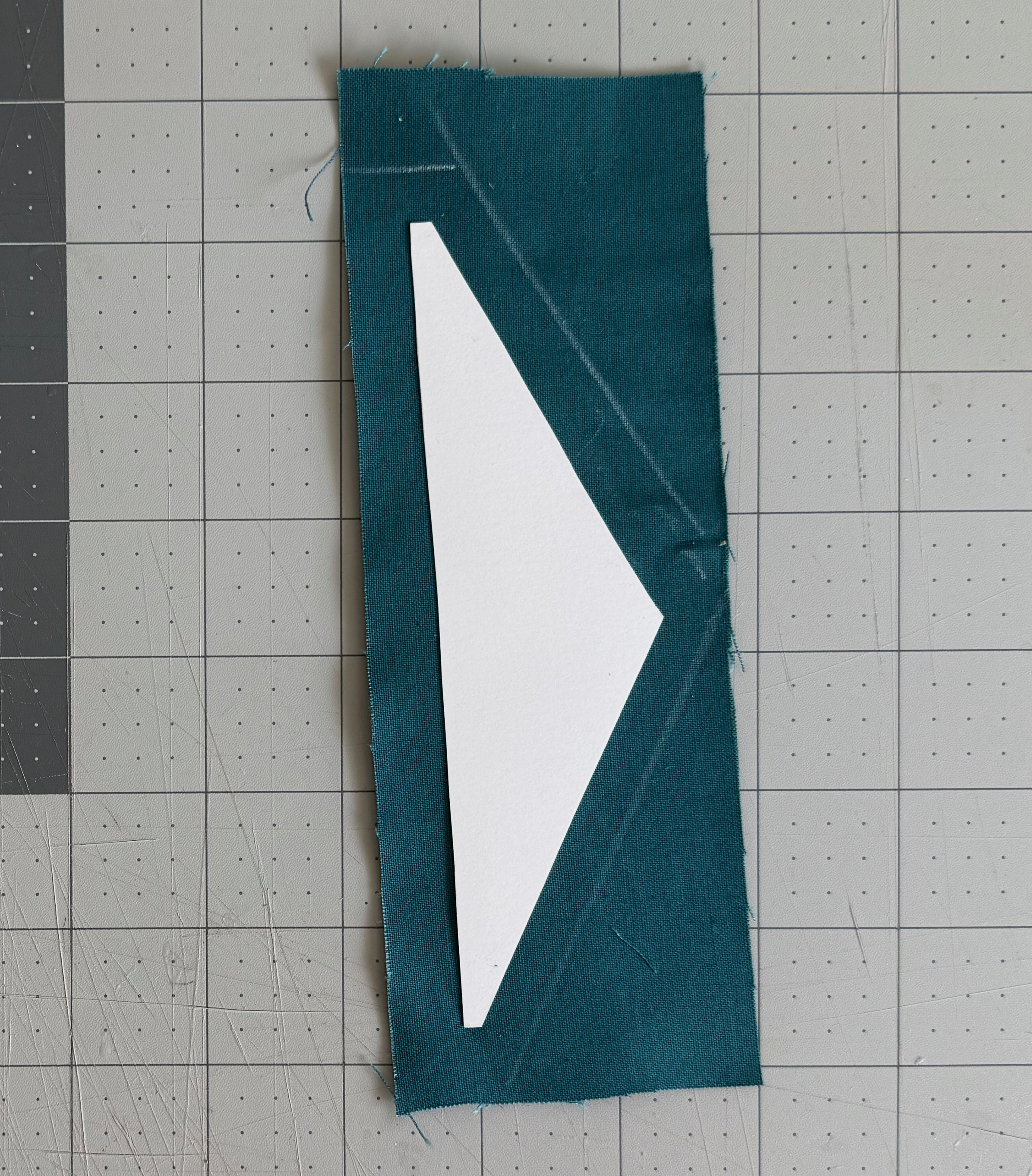 Fabric cut around an irregular cardstock lining with its buffer intact