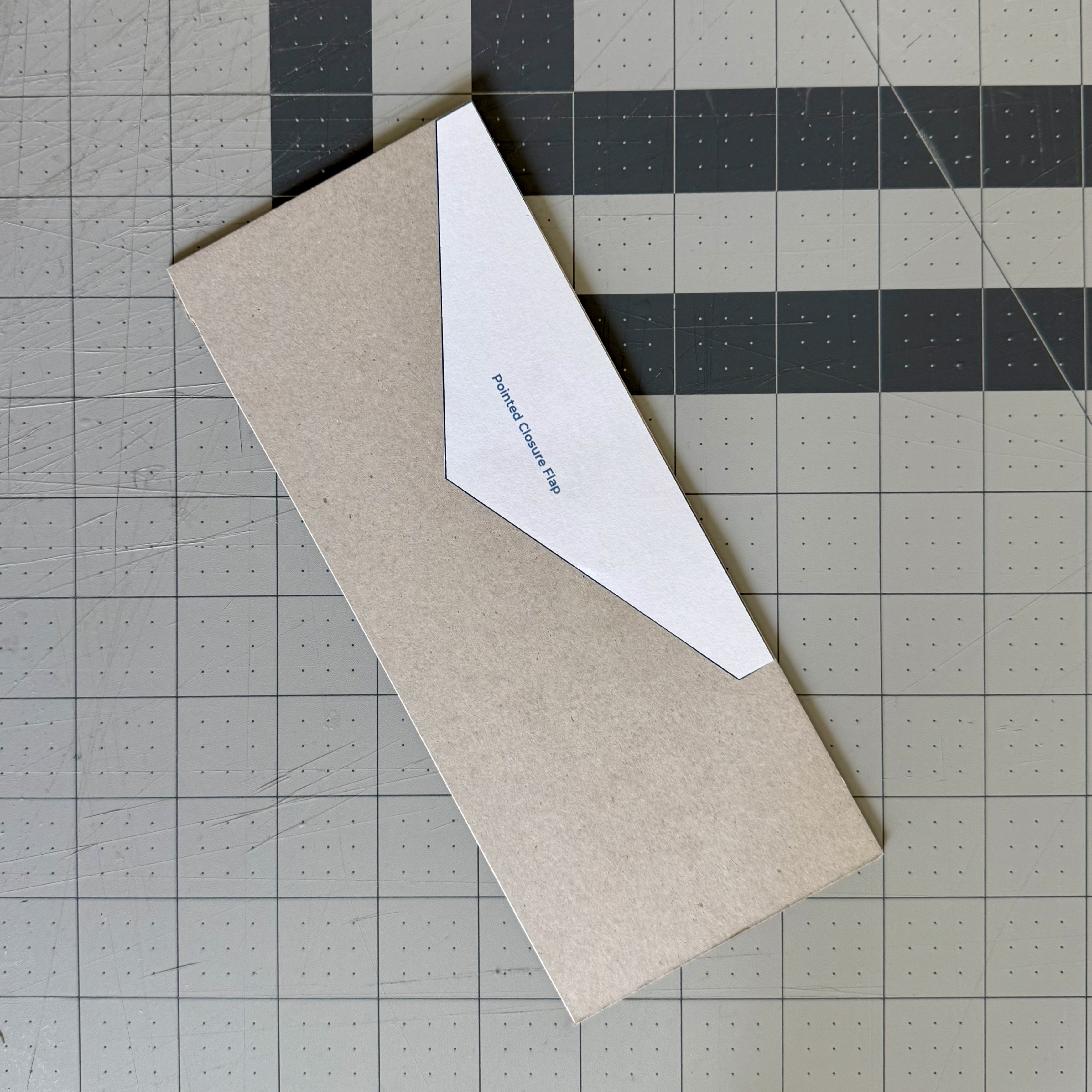 Paper pattern cut out and positioned on chipboard
