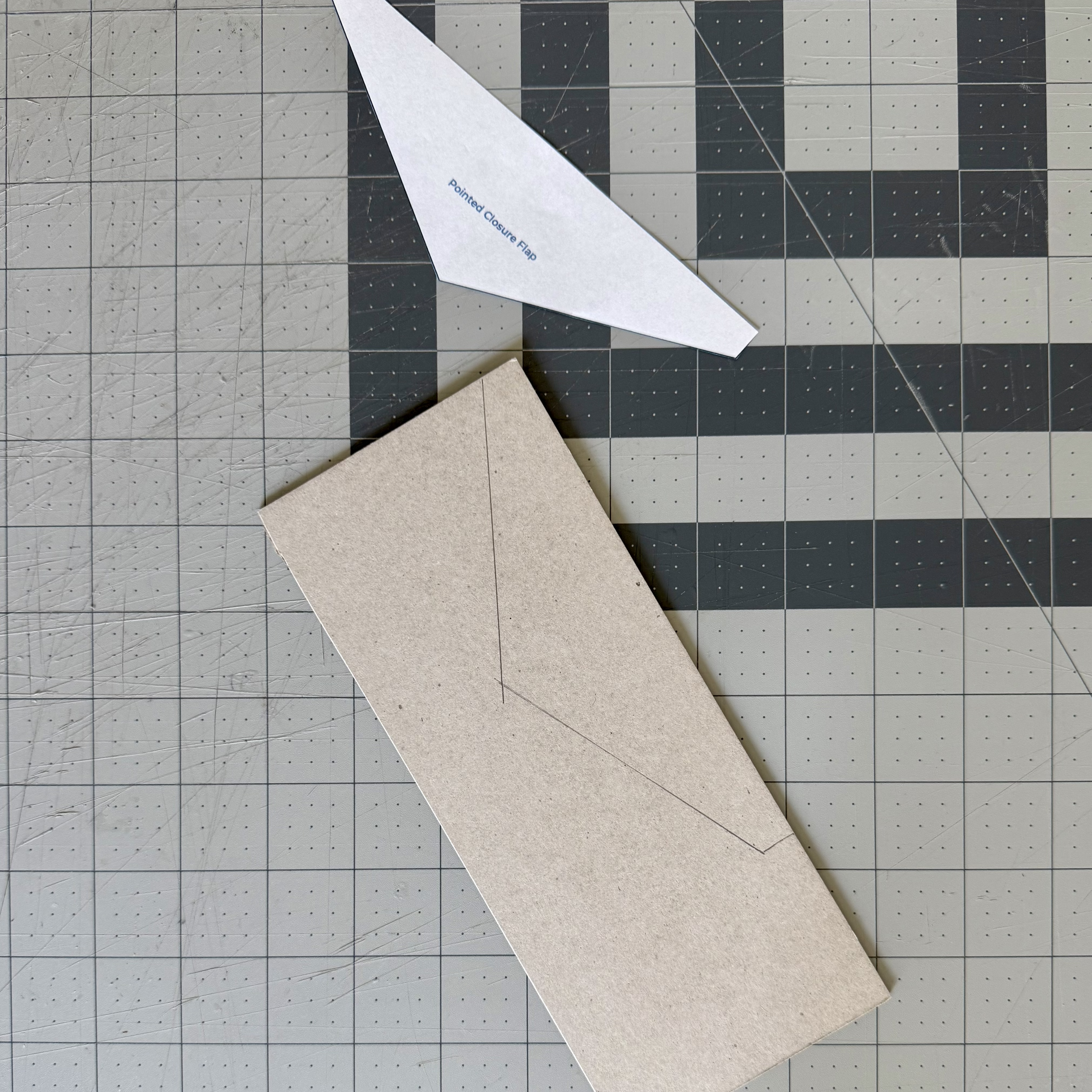 Irregular paper pattern removed after its outline was traced onto chipboard