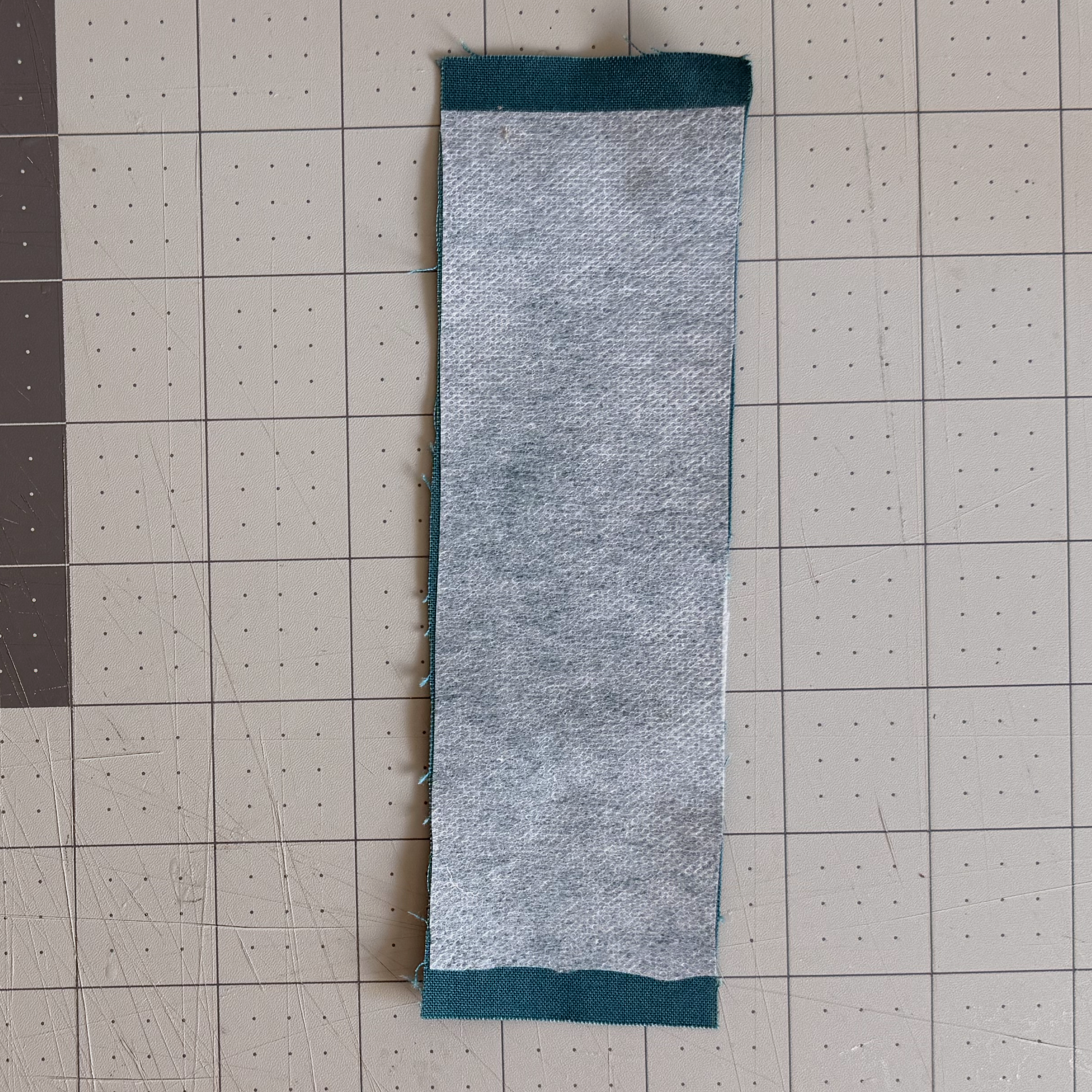 Fusible interfacing positioned rough side down on the wrong side of fabric