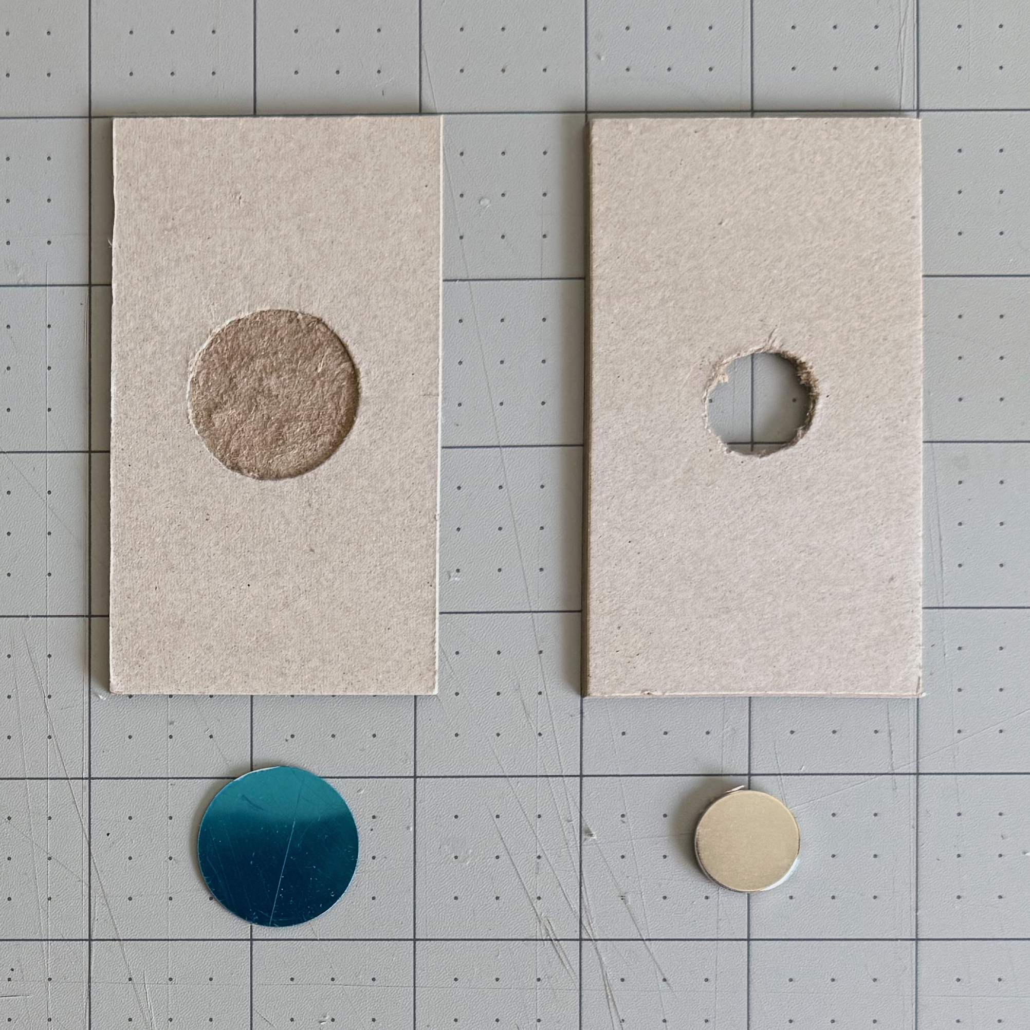 Shallow metal-disc recess and deeper magnet opening cut into chipboard