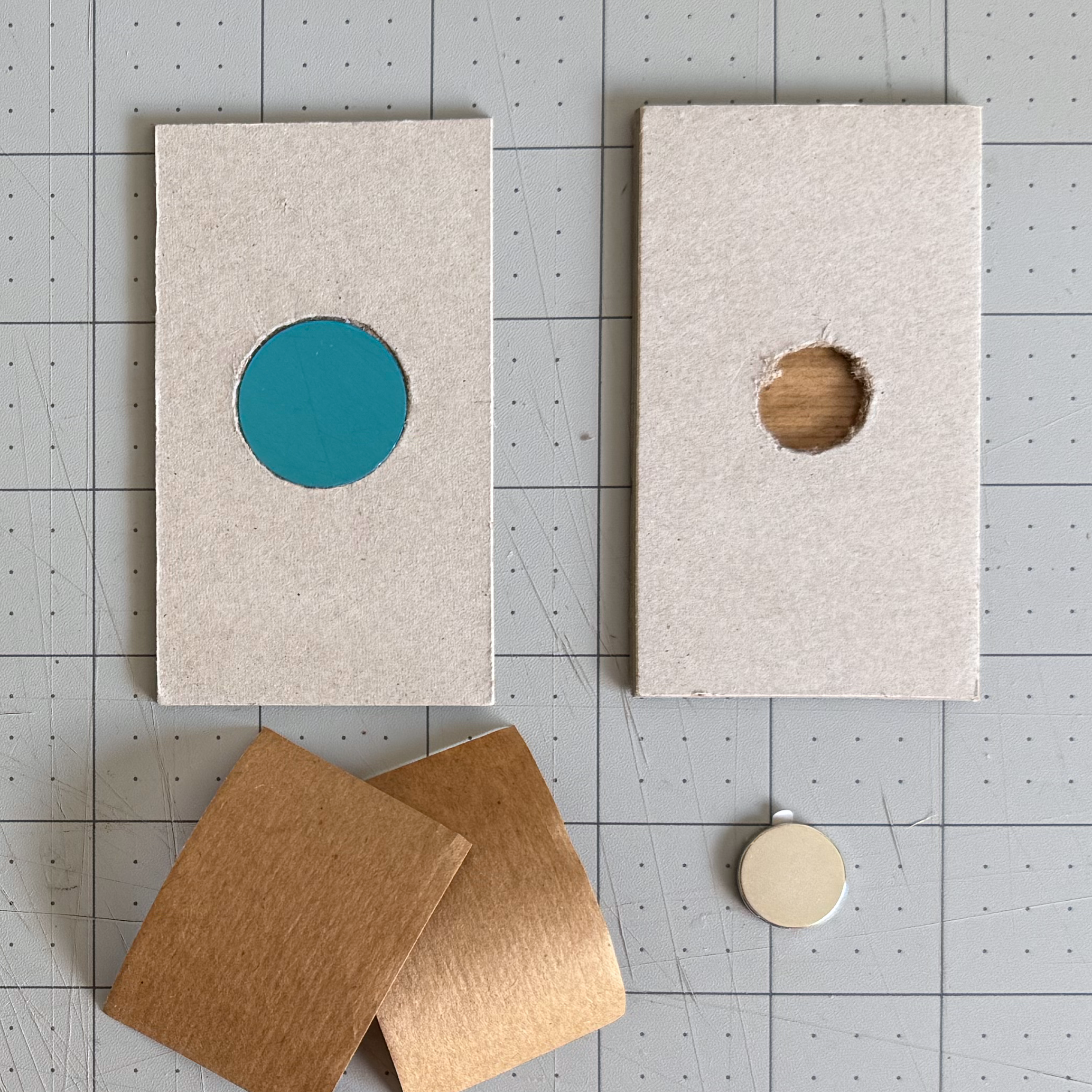 Magnet and metal disc placed into their chipboard recesses