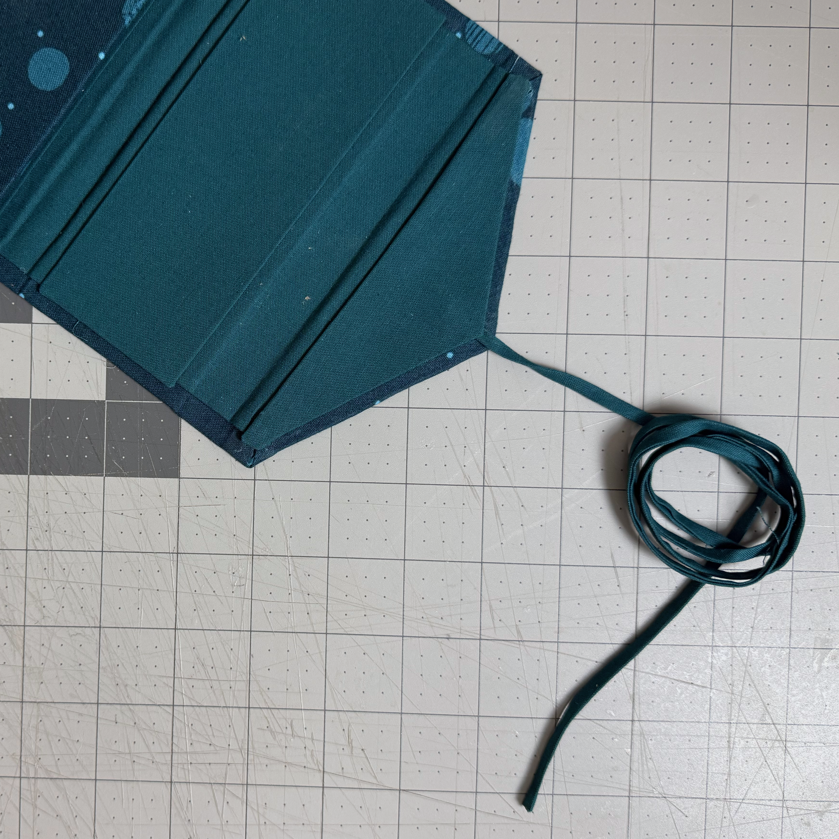 Fabric tie anchored to the project before the lining card is installed