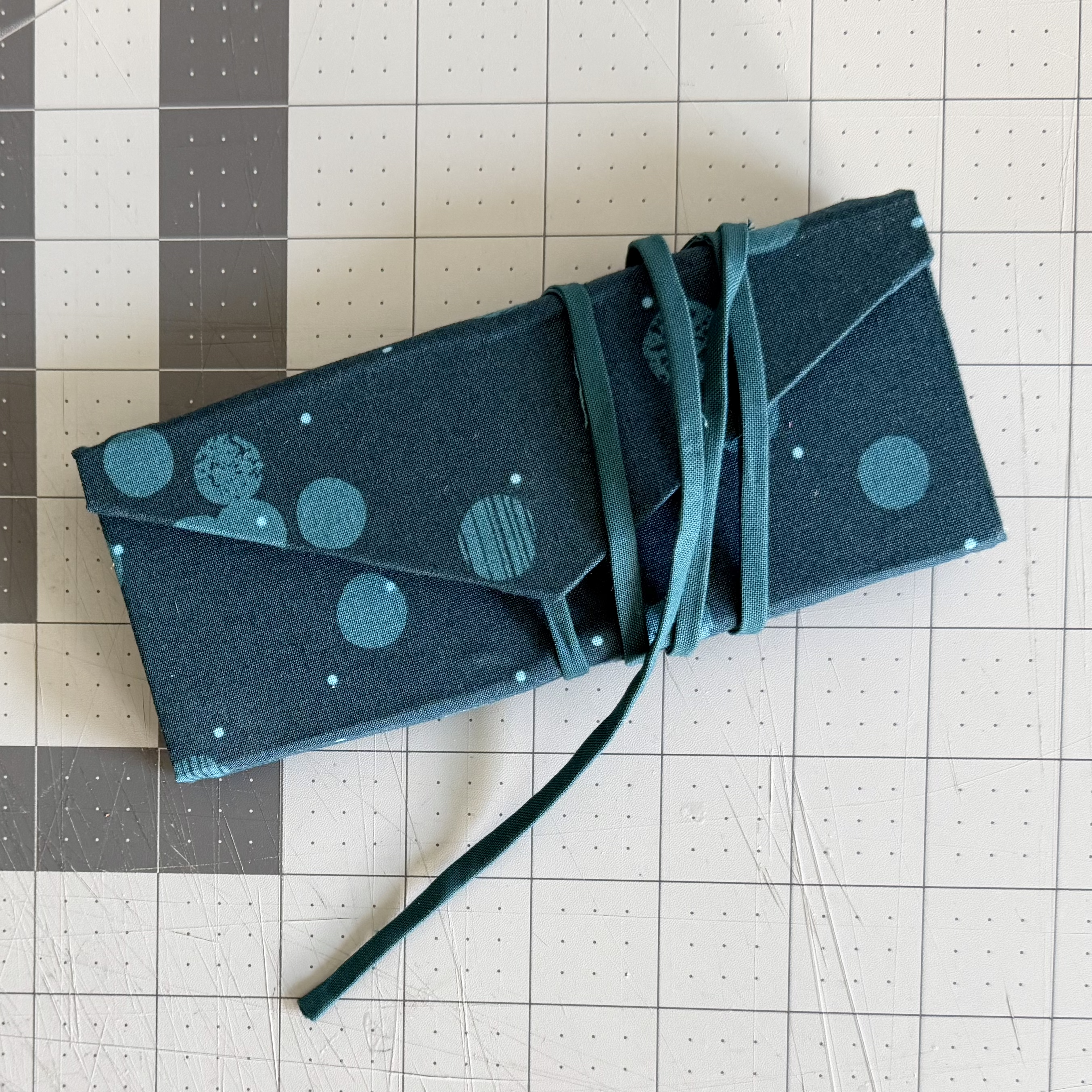 Finished fabric-covered case secured with its attached wraparound tie closure