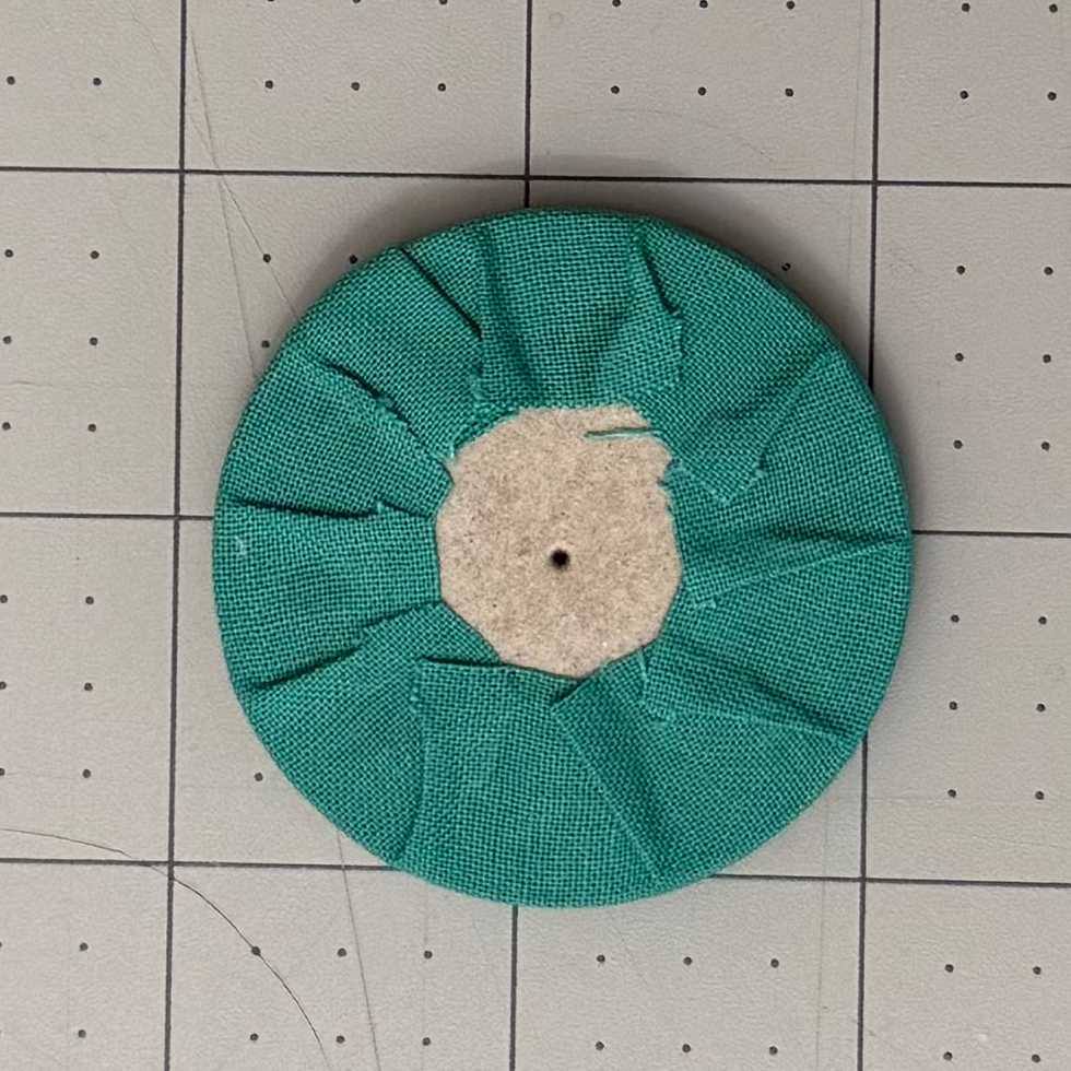 Completed fabric tabs wrapped around a chipboard circle